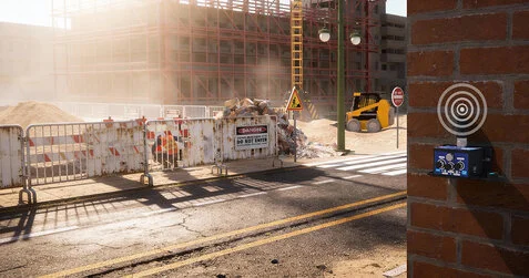 Satevis wireless inclinometer mounted on a brick wall monitoring a construction site, illustrating structural health monitoring installation and automatic zeroing calibration.